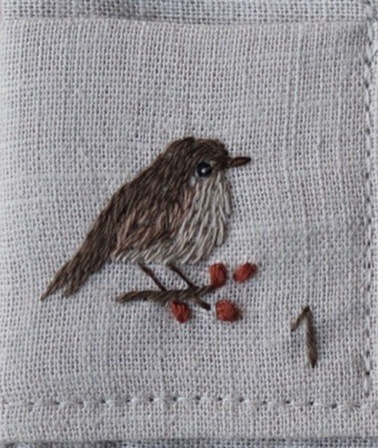 A little sparrow on a berry twig, stitched on linen